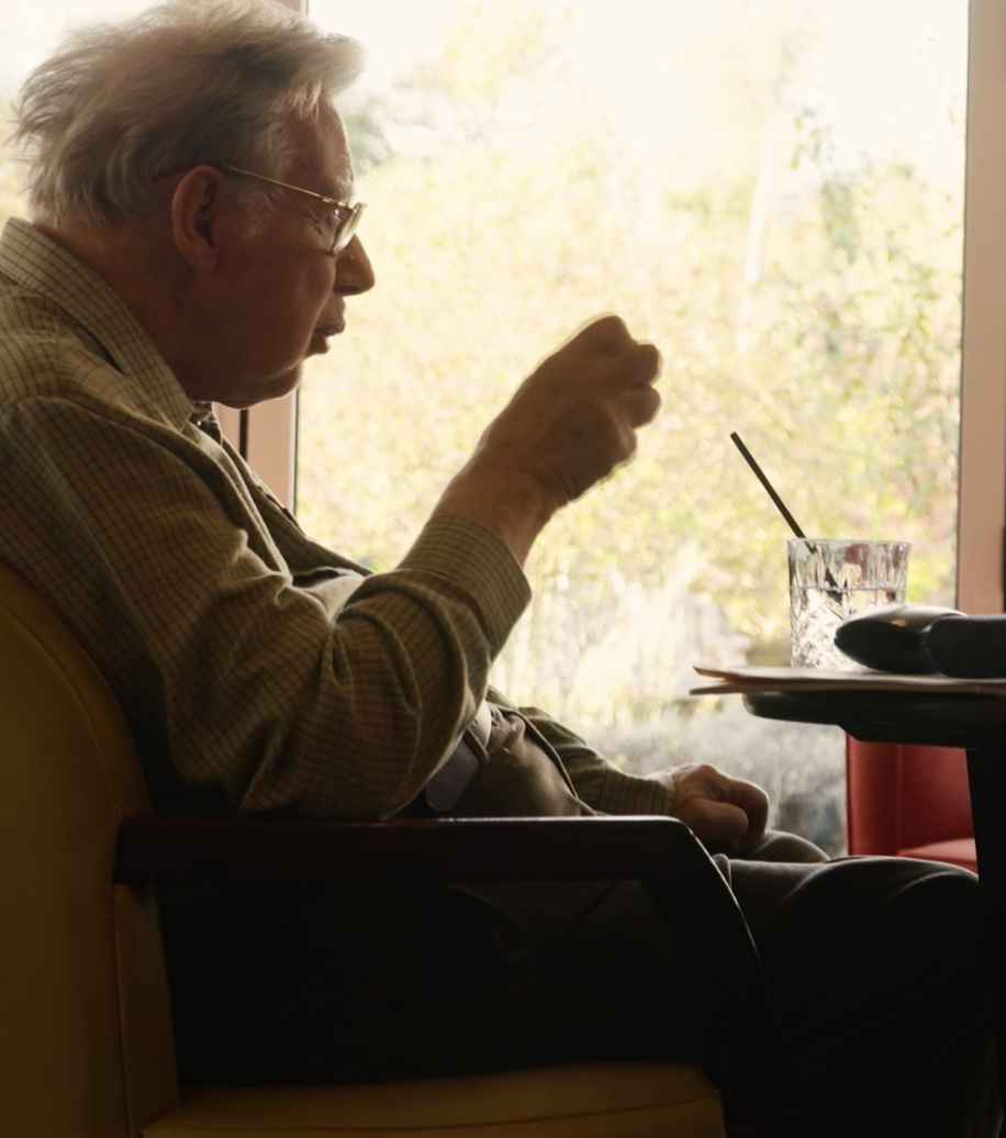 A kind, old man conversing.